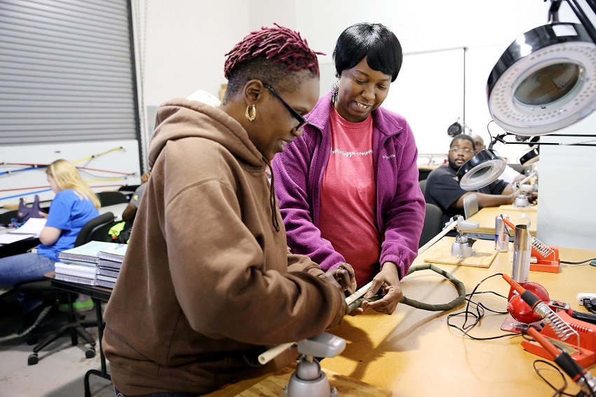 Starkville resident Kim Coats, at left, and Columbus resident Teresa Brooks, work on a cable during an Avionics and Cabling course at East Mississippi Community College. Employees who complete aerospace-related programs at EMCC are in high demand by local manufacturers.